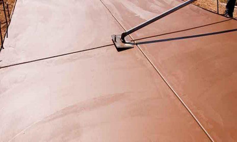 Terracotta coloured concrete slab being finished in Auckland